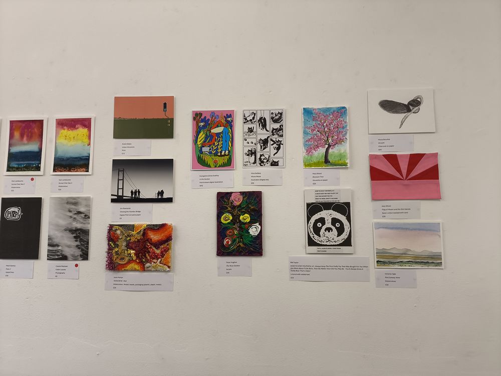 Charcoal drawing on a postcard hung at an exhibition.