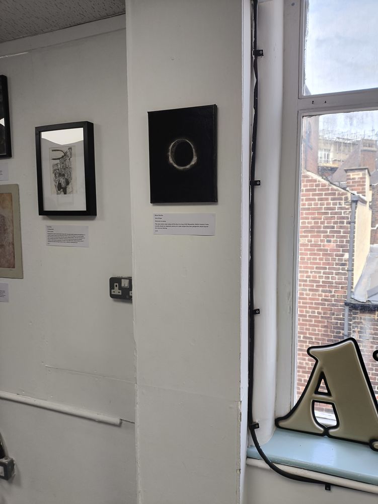 charcoal drawing hung at an exhibition
