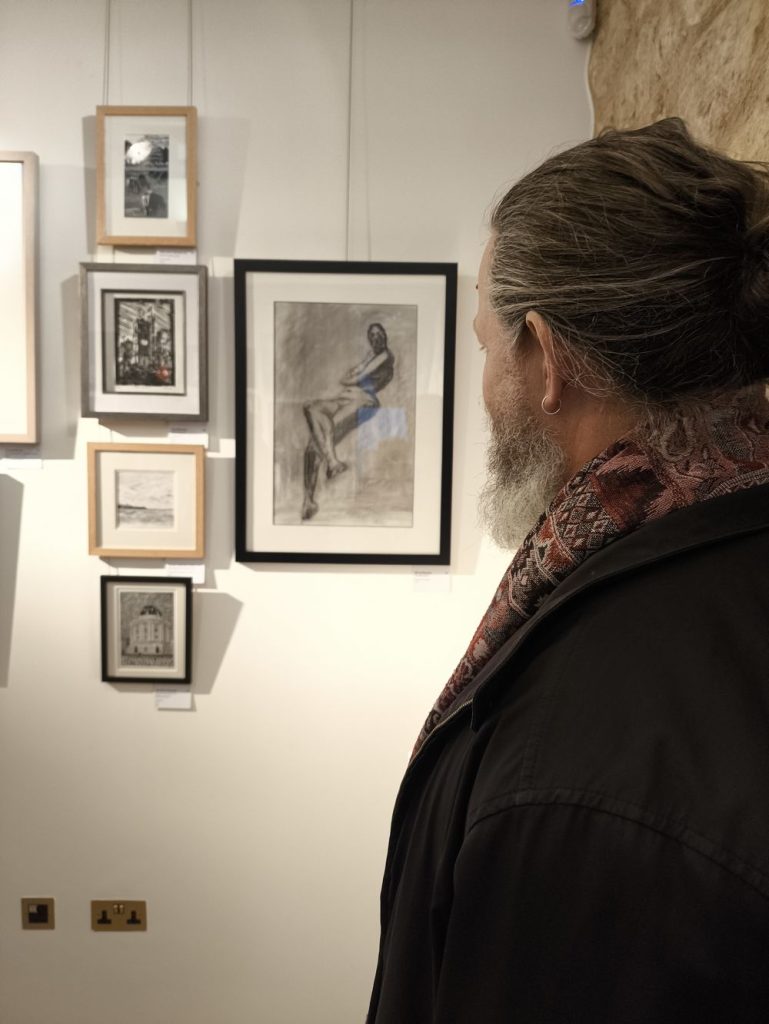 Someone is looking at the charcoal drawing You did what? exhibited at the Oxford art society open exhibition 2026